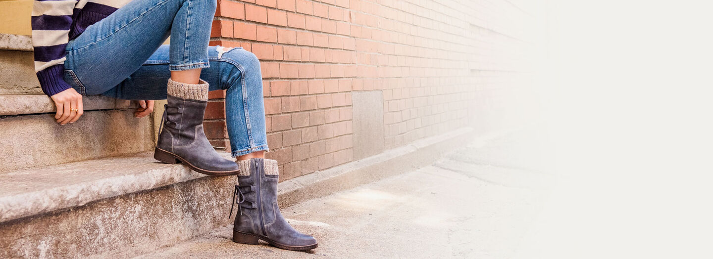 A woman wearing the Salem boot in blue/grey suede.