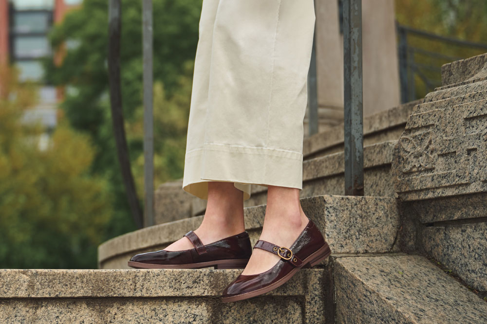 A woman wearing the Brewer mary jane in Cognac (brown).