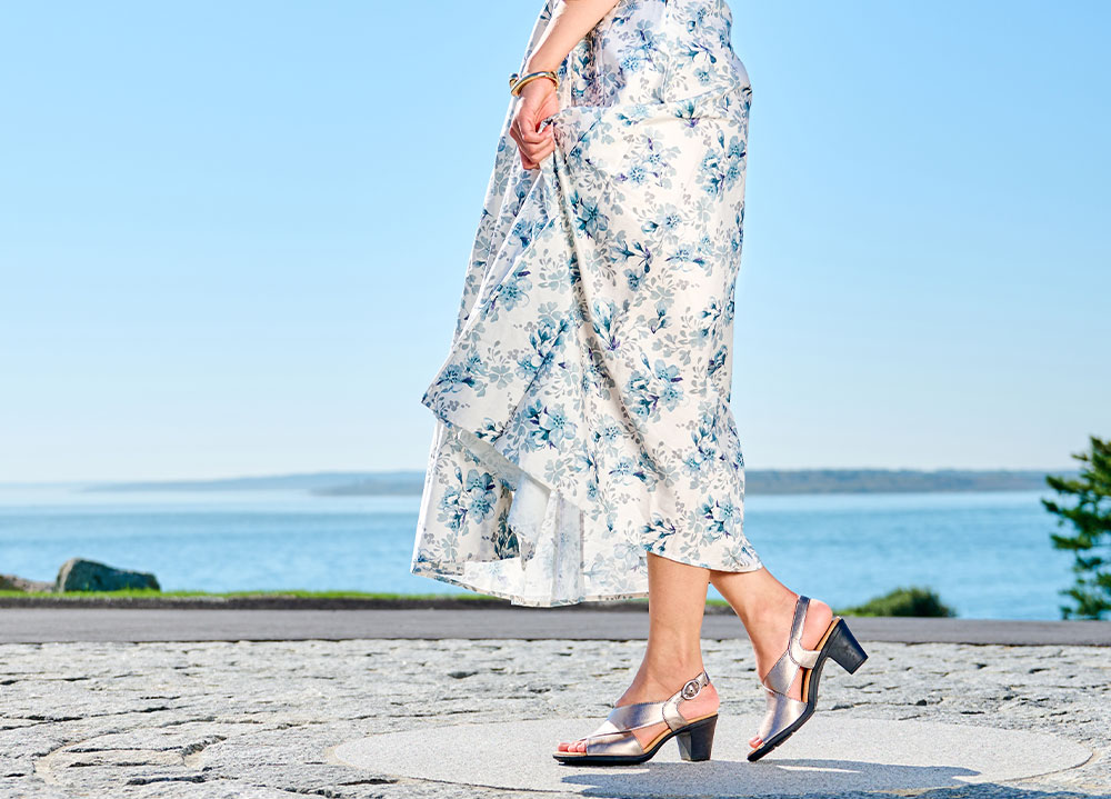 A woman wearing the Katara heels in metallic.